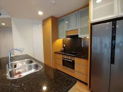 a kitchen with a sink and a stainless steel refrigerator at Stylish Large 3guests 1br St Mary Residences in Kuala Lumpur
