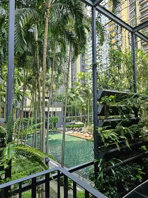 a view of a pool from a building with palm trees at Stylish Large 3guests 1br St Mary Residences in Kuala Lumpur