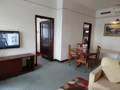 a living room with a couch and a table at DOUBLE DELUXE APARTMENT AT BERJAYA TIMES SQUARE kL in Kuala Lumpur