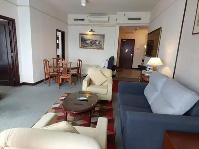 a living room with a couch and chairs and a table at DOUBLE DELUXE APARTMENT AT BERJAYA TIMES SQUARE kL in Kuala Lumpur