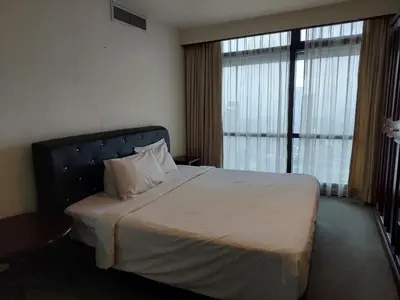 a bedroom with a large bed with a large window at DOUBLE DELUXE APARTMENT AT BERJAYA TIMES SQUARE kL in Kuala Lumpur