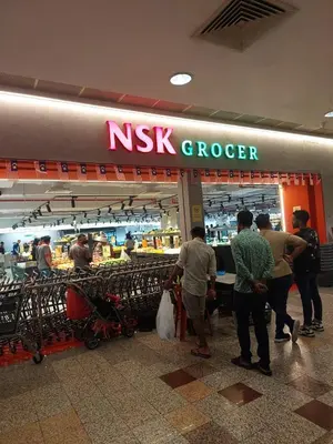 a group of people standing outside of a nk grocery store at DOUBLE DELUXE APARTMENT AT BERJAYA TIMES SQUARE kL in Kuala Lumpur