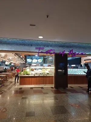 a food court in a mall with people walking around at DOUBLE DELUXE APARTMENT AT BERJAYA TIMES SQUARE kL in Kuala Lumpur