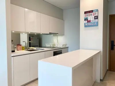 a kitchen with white cabinets and a white counter top at Sky Suite @ KLCC - 3BR KLCC View in Kuala Lumpur