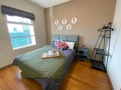 a bedroom with a bed with a tray on it at Sky Suite @ KLCC - 3BR KLCC View in Kuala Lumpur