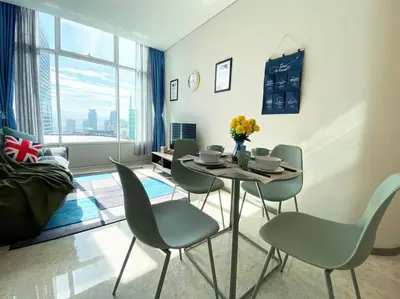 a dining room with a table and chairs and a large window at Sky Suite @ KLCC - 3BR KLCC View in Kuala Lumpur