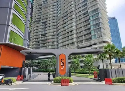 a train in front of a tall building at Sky Suite @ KLCC - 3BR KLCC View in Kuala Lumpur