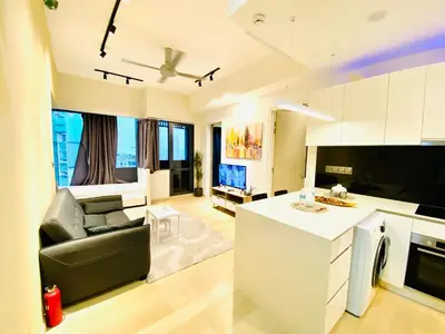 a kitchen and living room with a couch and a table at Star residence by KLCC in Kuala Lumpur