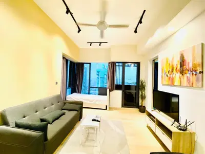 a living room with a couch and a bed at Star residence by KLCC in Kuala Lumpur