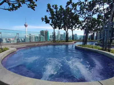 a hot tub on the roof of a building with trees at 1 Room 1 Bathroom The Robertson KLCC in Kuala Lumpur