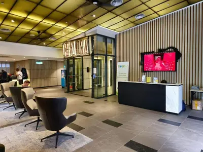 a lobby with a desk and chairs in a building at Ceylonz Suites Bukit Bintang by KL ONE in Kuala Lumpur