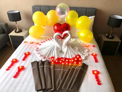 a bed with two swans made out of balloons at Ceylonz Suites Bukit Bintang by KL ONE in Kuala Lumpur