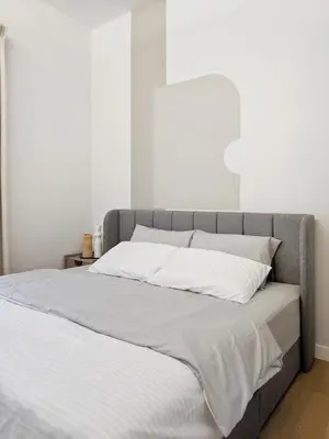 a bed with white sheets and pillows on it at Sentral Suites Kl Sentral By Luxe Home in Kuala Lumpur