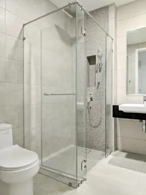 a bathroom with a shower with a toilet and a sink at Sentral Suites Kl Sentral By Luxe Home in Kuala Lumpur
