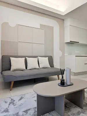 a living room with a couch and a table at Sentral Suites Kl Sentral By Luxe Home in Kuala Lumpur