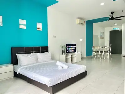 a bedroom with a large bed with a blue wall at Q Suite @ Queensville Kuala Lumpur by Moka in Kuala Lumpur