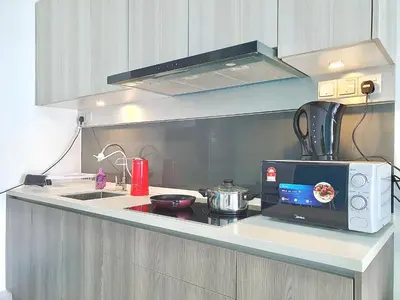 a kitchen with a microwave and a stove top oven at Q Suite @ Queensville Kuala Lumpur by Moka in Kuala Lumpur