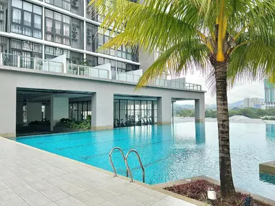 a swimming pool with a palm tree in front of a building at Q Suite @ Queensville Kuala Lumpur by Moka in Kuala Lumpur
