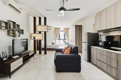 a living room with a couch and a tv at Q Suite @ Queensville Kuala Lumpur by Moka in Kuala Lumpur