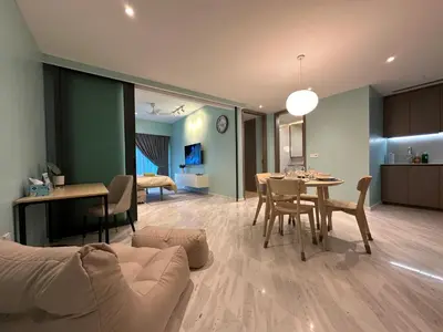 a living room with a couch and a dining room at Eaton Residences KLCC by Romeo Bnb in Kuala Lumpur
