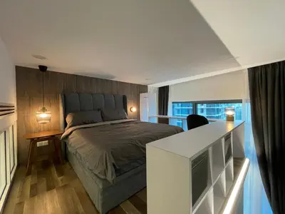 a bedroom with a bed and a desk with a television at Eaton Residences KLCC by Romeo Bnb in Kuala Lumpur