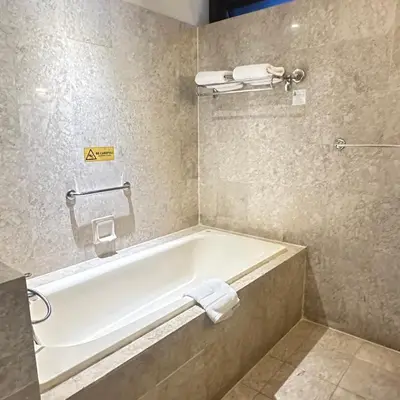 a bathroom with a bath tub in a hotel room at Peak Suites At Times Square in Kuala Lumpur