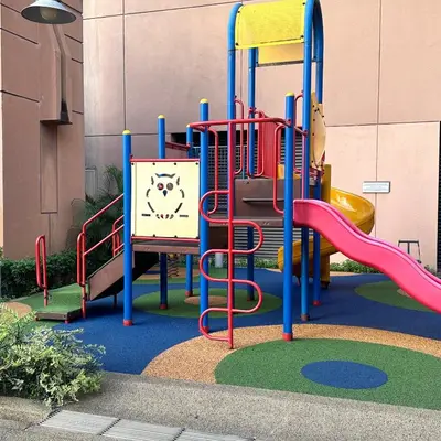 a playground with a slide in front of a building at Peak Suites At Times Square in Kuala Lumpur