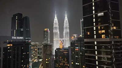 a view of the kuala lumpur city skyline at night at 8 Kia Peng Suites KLCC by Luna in Kuala Lumpur