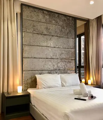 a bedroom with a white bed with a large headboard at 8 Kia Peng Suites KLCC by Luna in Kuala Lumpur