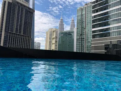 a large pool of water in a city with tall buildings at 8 Kia Peng Suites KLCC by Luna in Kuala Lumpur