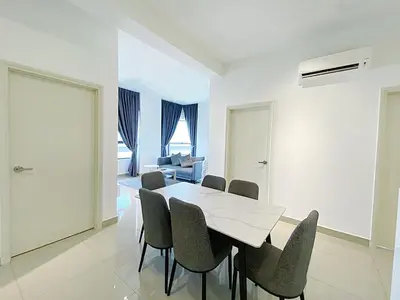 a white dining room with a table and chairs at Arte Plus Ampang in Kuala Lumpur