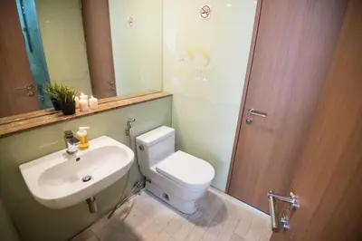 a bathroom with a white toilet and a sink at Soho Suites KLCC by Minsha in Kuala Lumpur