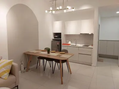 a kitchen with a wooden table in a room at Chambers Platinum Suite Kuala Lumpur in Kuala Lumpur