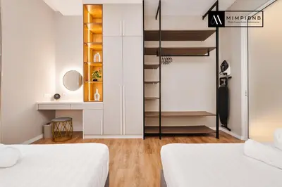 two beds in a small room with a staircase at Quill Residences Suite by Mimpi B&B in Kuala Lumpur