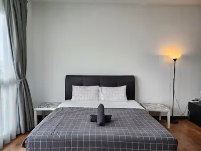 a bedroom with a bed with a stuffed animal on it at Regalia Suites Kuala Lumpur KLCC in Kuala Lumpur