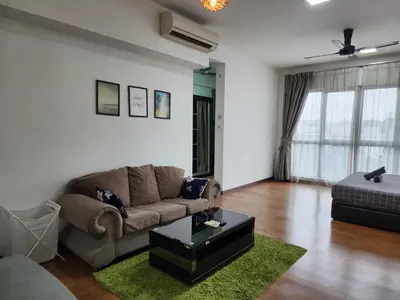 a living room with a couch and a table at Regalia Suites Kuala Lumpur KLCC in Kuala Lumpur
