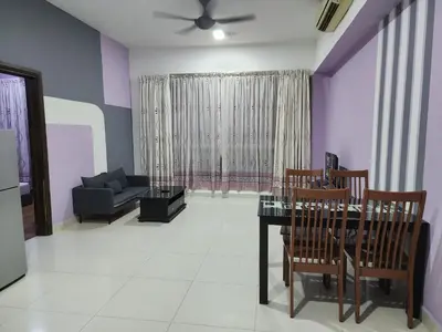 a living room with a dining table and a couch at Regalia Suites Kuala Lumpur KLCC in Kuala Lumpur