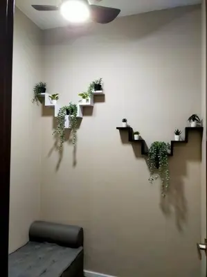 a wall with stairs with potted plants on it at Luxurious Staycation Apartment in Ampang