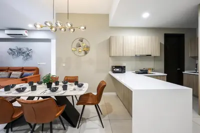 a kitchen and living room with a table and chairs at Luxurious Staycation Apartment in Ampang