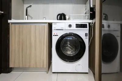 a washer and dryer under a counter in a kitchen at Luxurious Staycation Apartment in Ampang