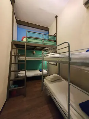 a room with three bunk beds in a room at Travel Hub Highstreet in Kuala Lumpur