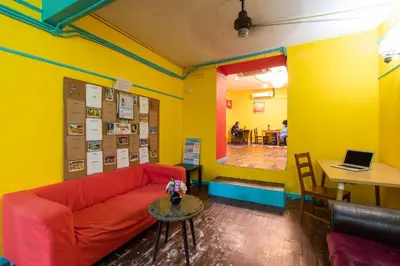 a living room with a red couch and a table at Travel Hub Highstreet in Kuala Lumpur