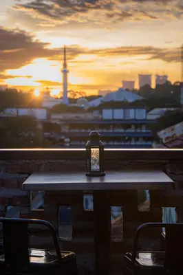 a candle sitting on a table with a view of a city at Travel Hub Highstreet in Kuala Lumpur