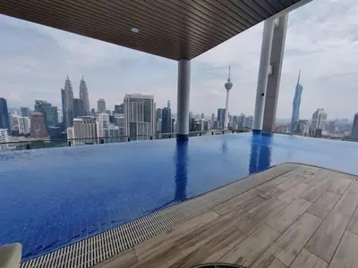 a swimming pool on top of a building with a city skyline at Wisma Infinitum Studio 5\u5206\u949f\u62b5\u8fbe KL \u5e02\u4e2d\u5fc3 in Kuala Lumpur