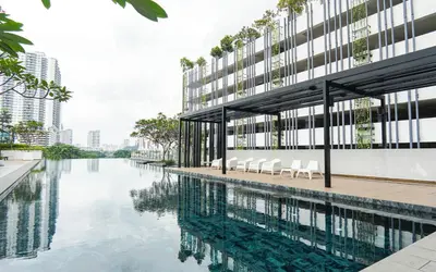 an external view of a building with a pool of water at VIVO at 9 Seputeh by Airhost in Kuala Lumpur