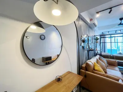 a living room with a mirror and a couch at Colony By Infinitum in Kuala Lumpur
