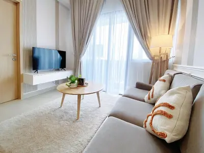 a living room with a couch and a tv at Colony By Infinitum in Kuala Lumpur