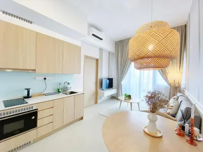 a kitchen with a table and a chandelier at Colony By Infinitum in Kuala Lumpur