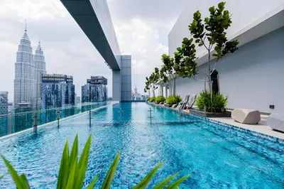 a swimming pool on the roof of a building with a city at Royce KLCC Kuala Lumpur City Centre by Dormeo Destinations in Kuala Lumpur