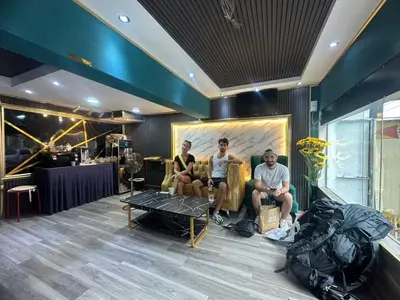 a group of three men sitting in a room at SS Grey Hotel in Kuala Lumpur